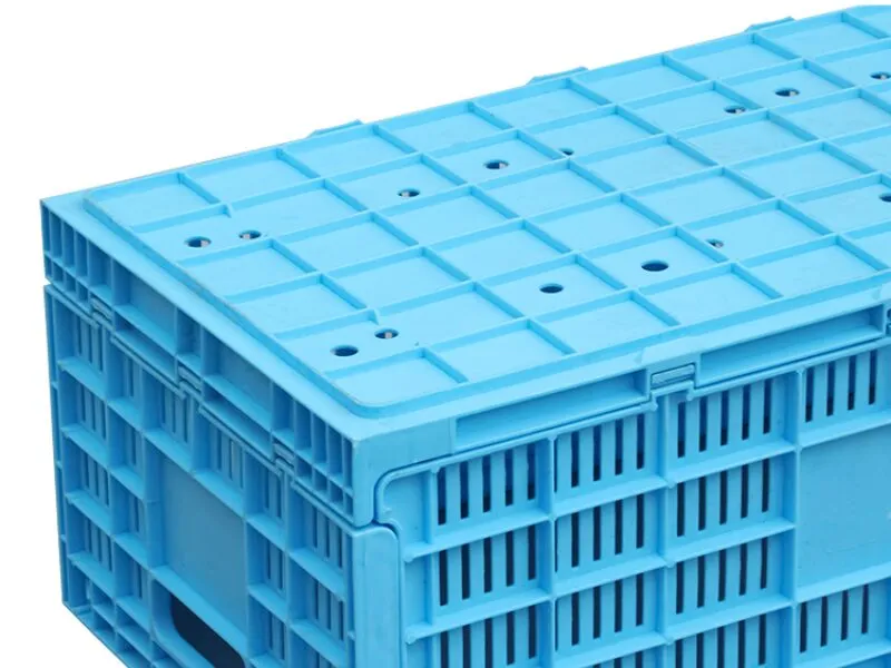 A blue ventilated plastic crate, suitable for assembly line integration, showing grid - like structure and stackable design.