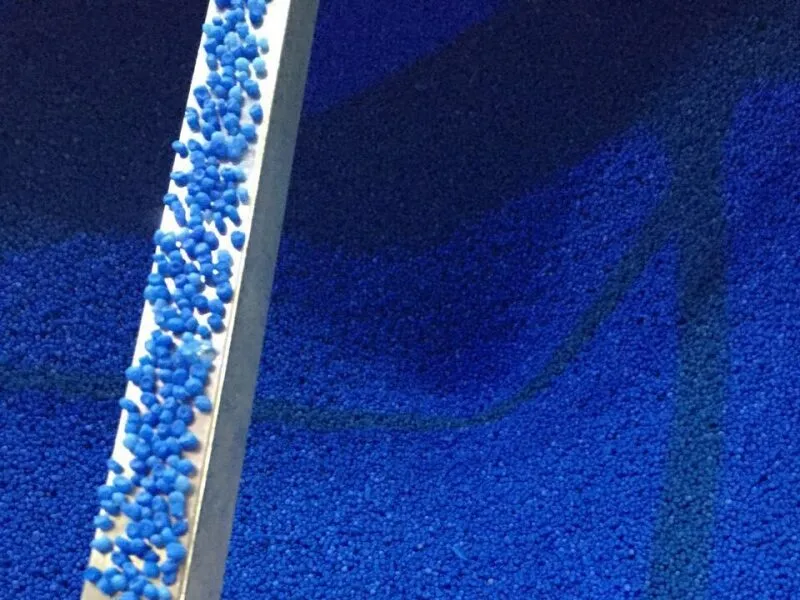 Blue plastic pellets, raw material for eco - friendly tote boxes.