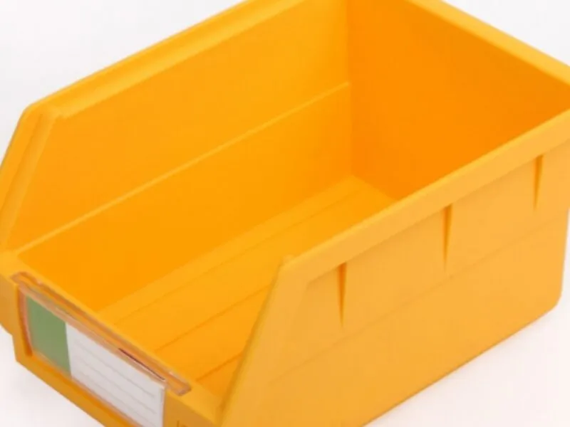Yellow pegboard plastic bin, open, for small parts.