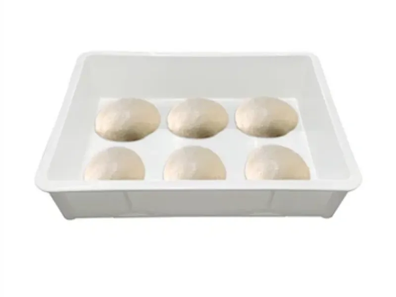 White plastic dough tray, with six dough balls, for pastry prep.